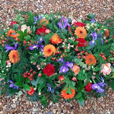 Orange, Red and Purple Casket Spray