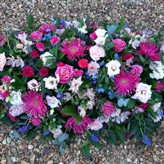 Casket Spray of Pink Flowers with Pink and Bule Spring Plants